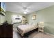 Cozy bedroom featuring tile flooring, a ceiling fan, and a window with natural light at 2214 Se Sawgrass Ct, Winter Haven, FL 33884