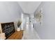 Inviting hallway featuring neutral paint, tile flooring and a view to the home's living spaces at 2214 Se Sawgrass Ct, Winter Haven, FL 33884