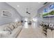 Inviting living room with a large sofa, neutral walls, and a large window offering plenty of natural light at 2214 Se Sawgrass Ct, Winter Haven, FL 33884