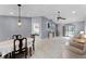 Spacious living area with tile flooring, a fan, and sliding glass doors to the outdoor space at 2214 Se Sawgrass Ct, Winter Haven, FL 33884