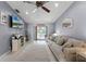 Comfortable living room with neutral walls, tile flooring, and sliding glass doors to the outside at 2214 Se Sawgrass Ct, Winter Haven, FL 33884