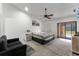 Comfortable main bedroom with a ceiling fan, sliding glass doors to the outside and an ensuite bathroom at 2214 Se Sawgrass Ct, Winter Haven, FL 33884