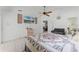 Spacious main bedroom featuring a bed, large-screen TV, and comfortable seating area at 2214 Se Sawgrass Ct, Winter Haven, FL 33884