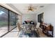Enclosed patio with tile floors, ceiling fan, glass table and backyard access at 2214 Se Sawgrass Ct, Winter Haven, FL 33884