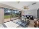 Enclosed patio with tiled flooring, ceiling fan, and sliding glass doors to the backyard at 2214 Se Sawgrass Ct, Winter Haven, FL 33884