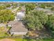 Aerial view of a fully fenced backyard with mature trees and a lawn, plus an outdoor living space at 2218 W Gore St, Orlando, FL 32805