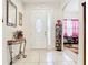 Bright entryway with tile floors, a decorative table, and an accent mirror at 2218 W Gore St, Orlando, FL 32805