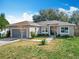 Charming one-story home with mature landscaping and a two-car garage at 2218 W Gore St, Orlando, FL 32805