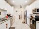 Modern kitchen featuring white cabinetry, stainless steel appliances, and granite countertops at 2218 W Gore St, Orlando, FL 32805