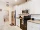 Well-lit kitchen with stainless steel appliances, granite countertops, and white cabinets at 2218 W Gore St, Orlando, FL 32805