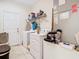 Simple laundry room with a white washer and dryer and tiled flooring at 2218 W Gore St, Orlando, FL 32805