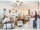 Comfortable living room featuring plush seating, light wood floors, and ceiling fan at 2218 W Gore St, Orlando, FL 32805