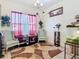 Cozy sitting area with accent chairs, red and white curtains, and a decorative lamp at 2218 W Gore St, Orlando, FL 32805