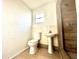 Bathroom with pedestal sink, toilet, and shower at 222 Haynes St, Daytona Beach, FL 32114