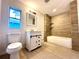 Updated bathroom with a modern vanity and tile shower/tub combo at 222 Haynes St, Daytona Beach, FL 32114