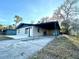 Front view of a renovated house with carport and yard at 222 Haynes St, Daytona Beach, FL 32114