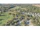 Aerial view of a community pool, clubhouse, and lush golf course in a desirable neighborhood at 25974 High Hampton Cir, Sorrento, FL 32776