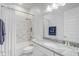 Stylish bathroom with white marble tile, granite countertop, and chrome fixtures at 25974 High Hampton Cir, Sorrento, FL 32776