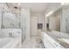 Bright bathroom features double vanity, marble floors, and a glass enclosed shower at 25974 High Hampton Cir, Sorrento, FL 32776