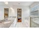 Bright bathroom features a double vanity, soaking tub, and glass-enclosed shower at 25974 High Hampton Cir, Sorrento, FL 32776