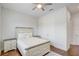 Bright bedroom features hardwood floors, ceiling fan, and a decorative bed frame at 25974 High Hampton Cir, Sorrento, FL 32776
