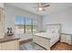 Bedroom with hardwood floors, ceiling fan, and lots of natural light at 25974 High Hampton Cir, Sorrento, FL 32776