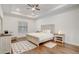 Spacious bedroom features hardwood floors, tray ceiling, ceiling fan, and neutral decor at 25974 High Hampton Cir, Sorrento, FL 32776