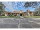 Exterior shot of the charming clubhouse with lush landscaping at 25974 High Hampton Cir, Sorrento, FL 32776