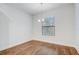 Empty room features hardwood floors, modern chandelier, and lots of natural light at 25974 High Hampton Cir, Sorrento, FL 32776