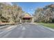 Welcoming neighborhood entrance with a covered portico and manicured landscaping at 25974 High Hampton Cir, Sorrento, FL 32776