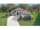 Aerial view of a modern single-Gathering home with beautiful landscaping and a paver driveway at 25974 High Hampton Cir, Sorrento, FL 32776