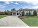 Beautiful home exterior with a brick driveway, manicured landscaping, and a gray tiled roof at 25974 High Hampton Cir, Sorrento, FL 32776