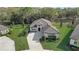 Aerial view of a modern single-Gathering home with beautiful landscaping and a paver driveway at 25974 High Hampton Cir, Sorrento, FL 32776
