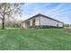 A bright, modern home featuring a well-manicured lawn and tasteful landscaping at 25974 High Hampton Cir, Sorrento, FL 32776