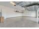 A well-lit garage featuring epoxy floors, storage racks, and ample space for parking and storage at 25974 High Hampton Cir, Sorrento, FL 32776