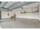 Spacious garage with epoxy floor, metal shelving, and ample storage and organization options at 25974 High Hampton Cir, Sorrento, FL 32776