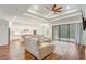 Open-concept living room with hardwood floors, a ceiling fan, and access to a patio at 25974 High Hampton Cir, Sorrento, FL 32776