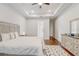 Bright main bedroom featuring hardwood floors, tray ceiling, and en suite bathroom at 25974 High Hampton Cir, Sorrento, FL 32776