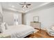Main bedroom with hardwood floors, tray ceiling, ceiling fan, and en suite bathroom at 25974 High Hampton Cir, Sorrento, FL 32776