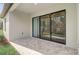 Covered patio featuring brick flooring and sliding glass doors leading inside at 25974 High Hampton Cir, Sorrento, FL 32776