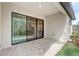 Covered patio featuring brick flooring and sliding glass doors leading inside at 25974 High Hampton Cir, Sorrento, FL 32776