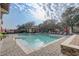 A view of the community pool area with lounge chairs and umbrellas at 25974 High Hampton Cir, Sorrento, FL 32776