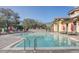 A view of the community pool with lounge chairs and an umbrella at 25974 High Hampton Cir, Sorrento, FL 32776