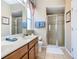 Bright bathroom offers double sinks, a walk-in shower, and neutral colors at 2632 Sand Hill Point Cir, Davenport, FL 33837