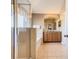 Bathroom showcasing a glass-enclosed shower, soaking tub, double vanity, and tile flooring at 2632 Sand Hill Point Cir, Davenport, FL 33837