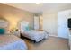 Shared bedroom showcasing two twin beds with stylish bedding, white nightstands, and ample closet space at 2632 Sand Hill Point Cir, Davenport, FL 33837