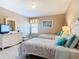 Bright bedroom boasts two twin beds with zebra-striped bedding, a dresser, and complementary decor at 2632 Sand Hill Point Cir, Davenport, FL 33837