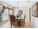 Elegant dining room with tile floors, large windows, and decorative chandelier at 2632 Sand Hill Point Cir, Davenport, FL 33837