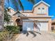 Charming two-story home with three car garage and brick paved driveway at 2632 Sand Hill Point Cir, Davenport, FL 33837