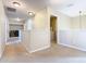 Hallway with carpet, neutral colors, access to utility room and bedrooms with natural light at 2632 Sand Hill Point Cir, Davenport, FL 33837